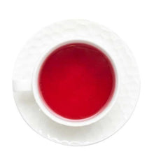 Load image into Gallery viewer, Brewed Mulled Wine Tea showing deep amber-red spiced infusion in glass cup