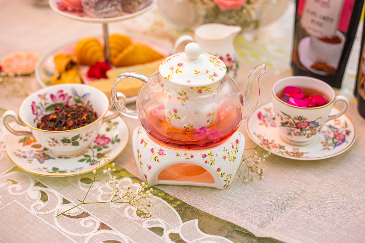 Dispur Tea Pouring brewed Divyntea whole leaf tea into teacup showcasing rich ...